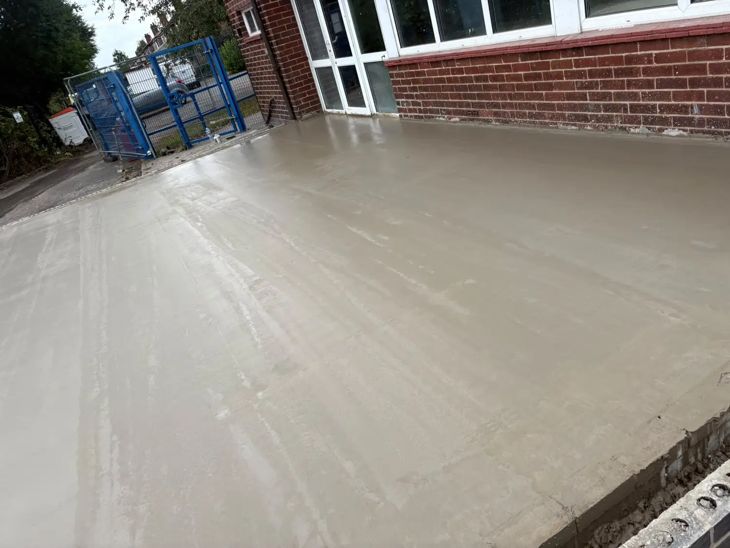 Smooth power floated concrete finish running up to the building's glazed elevation